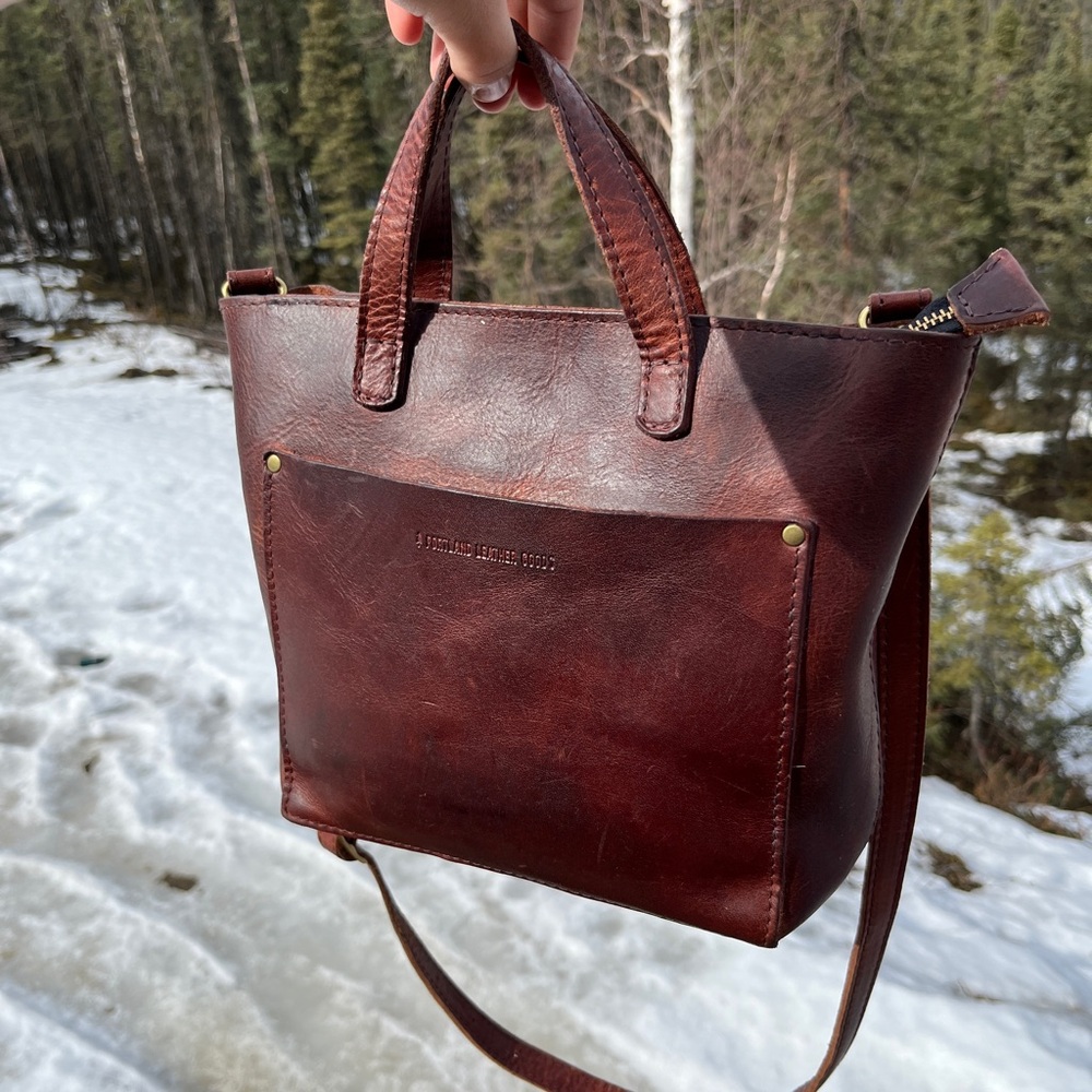 Portland Leather mini crossbody tote Brown with a zipper.